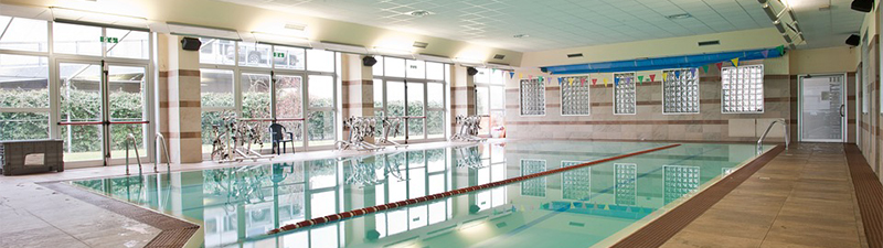 What are the advantages and constraints of an indoor swimming pool?